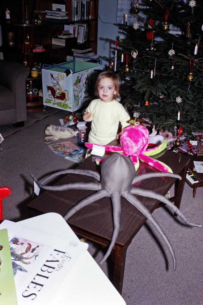 The author as a toddler with two stuffed octopuses.